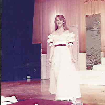 A color photograph of the pre-judging of the Miss Brunswick Contestant #1 Vicky Brown in evening gown..