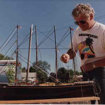 A photo view of a man working on a ship model. 8/12/1989.