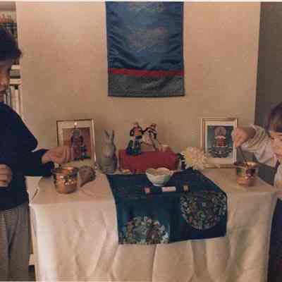 A photo view of two children lighting religious candles. 12/19/1988.