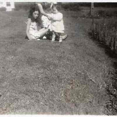 Two Unidentified Children Sitting on a Lawn
