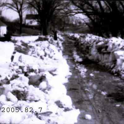 A photo of road cut through a large pile of ice.