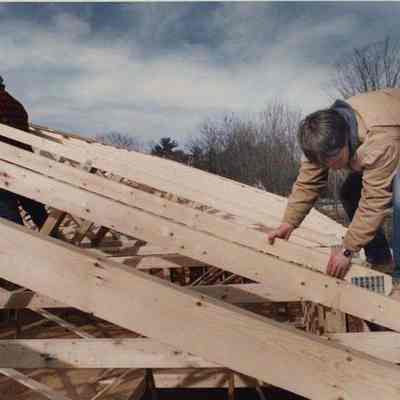 A photo view of 2 carpenters at work. 3/16/1992.