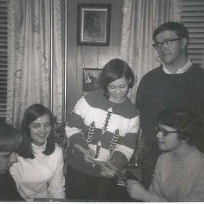 A B/W photograph of 4 people.