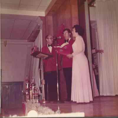 M. C. Gerry Menard looking on stage