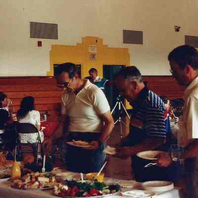 Gene Gagne, Mr. Burke and Gerry getting food.