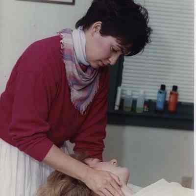 A photo view of a lady giving a massage. 11/27/1989.