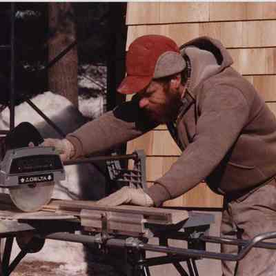 A photo view of a carpenter working. 2/29/1988.