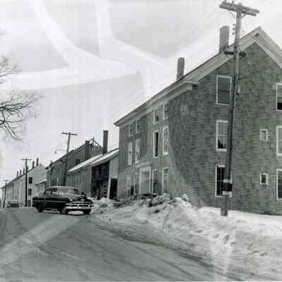 A photo of Mill Street buildings. 3/20/1956.