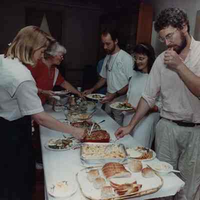 A photo view of a serving line at a pot luck supper. 8/11/1989.