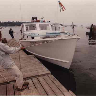A photo view of men docking a boat. 7/21/1989.