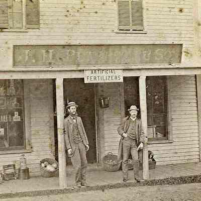 Unidentified men in front of JH Peterson's store