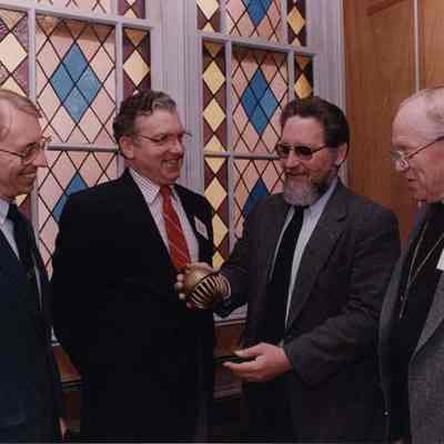 A photo view of four men. 5/19/1989.