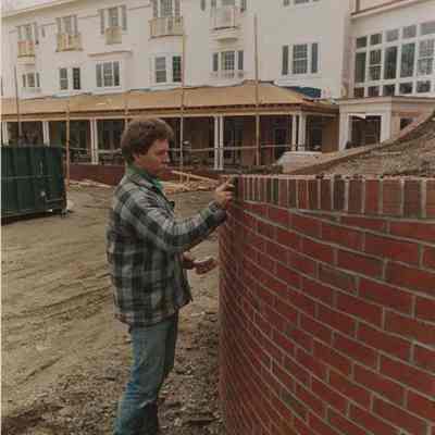 A photo view of a bricklayer at work. 4/11/1988.
