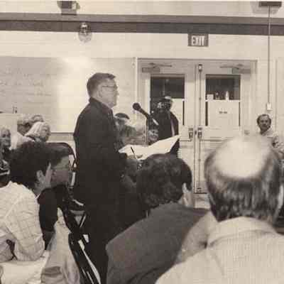 A photo view of a man speaking. 8/10/1992.