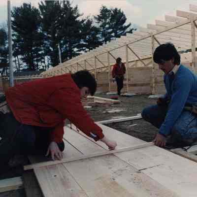 A photo view of 2 carpenters at work. 5/3/1989.