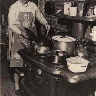 A photo view of Jill McCollum cooking. 1/18/1982.
