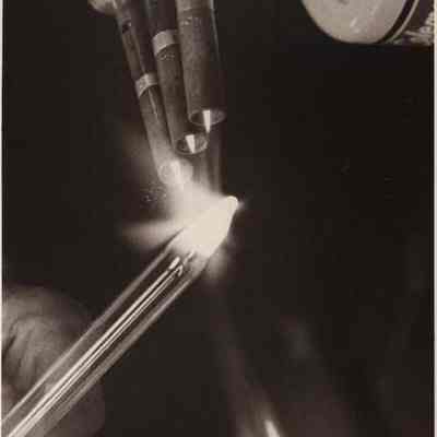 A photo view of Herbert Merrill demonstrating glass blowing. 4/17/1978.