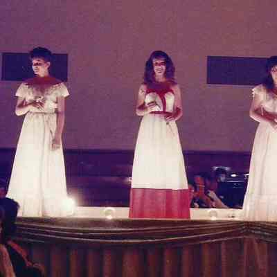 A color photograph of the Teen Queen contestants doing a series of quater turns.