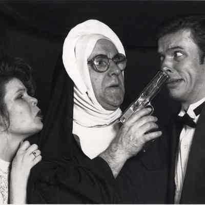 A photo view of three people acting in a play. 4/16/1992.