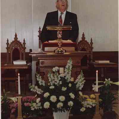A photo view of a preacher in church. 4/8/1988.