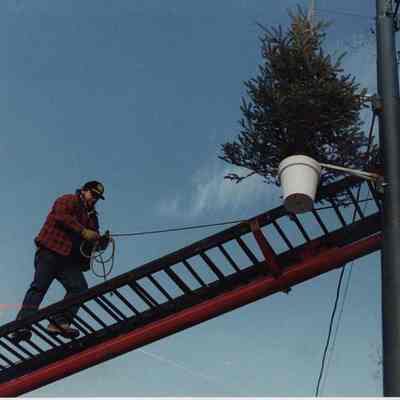 A photo view of a man walking on a ladder. 1/5/1990.