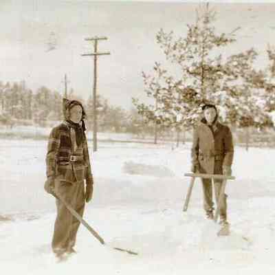 Two Unidentified Boys Clearing a Skating Rink