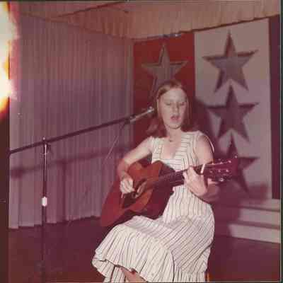 Elizabeth Coffin rehearsing her singing and playing the guitar.