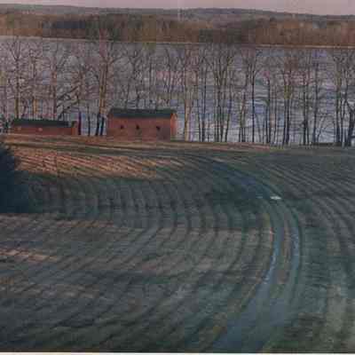 A photo view of a building and mowed fields. 12/27/1988.
