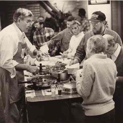A photo view of a man serving food. 11/19/1992.
