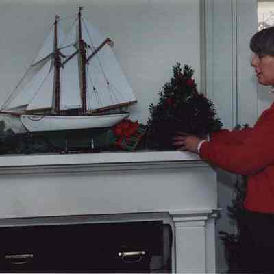 A photo view of a lady decorating her home. 12/4/1987.