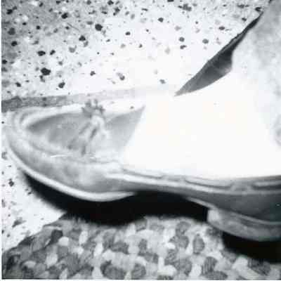 A B/W photograph of somebody's shoe.