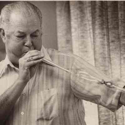 A photo view of Herbert Merrill blowing a glass bubble. 4/17/1978.