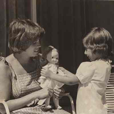 A photo view of a mother & daughter playing with dolls. 7/11/1978.