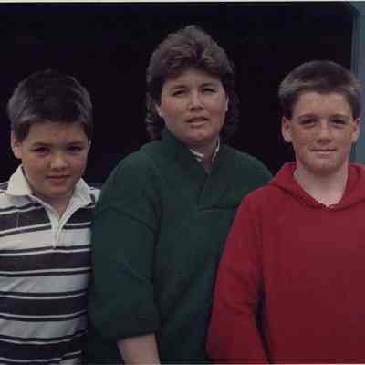 A photo view of a woman with 2 boys. 4/24/1989.