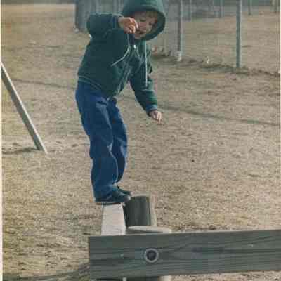 A photo view of a boy playing in a playground. 12/30/1988.