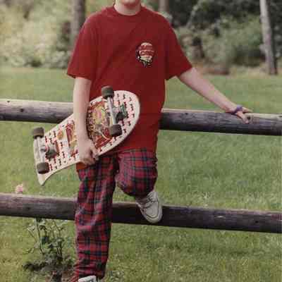 A photo view of a boy with a skate board. 8/28/1989.