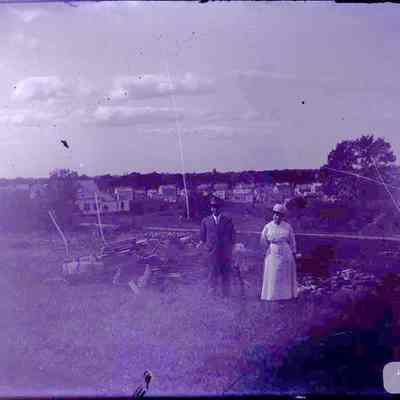 A man and a woman standing outdoors.