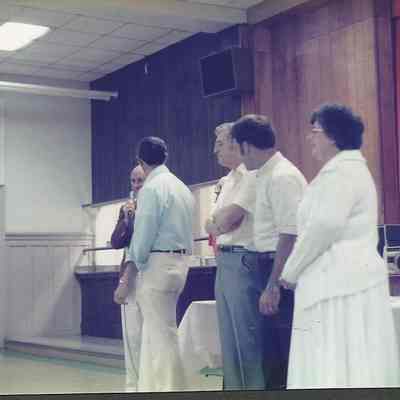 A color photograph of Gerry Menard praising Gene Gagne for the work he has done.