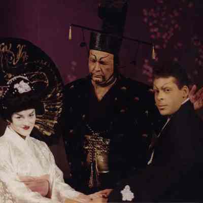 A photo view of three people in costume. 11/16/1989.
