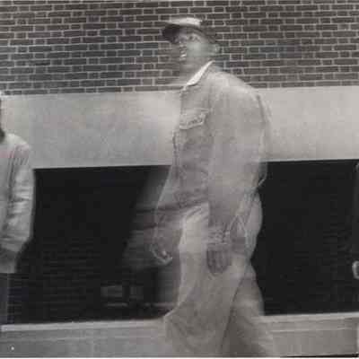 A photo view of 3 men in front of the Passit Lounge. 5/7/1992.