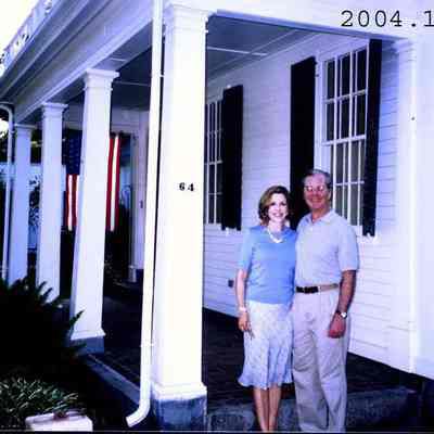 A photo of Megan and Mike Adams standing by their porch at 64 Federal Street.