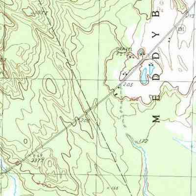 Meddybemps Lake , West, U.SGS Topo Map 1987: Eastern Surplus salvage yard is marked by several buildings and a driveway beside Route 191 on this USGS topogrpahical map of Meddybemps, Maine, in 1987.