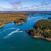          Reversing Falls, between Leighton's Neck (left), and Falls Island (right); Aerial view of the Reversing Falls looking east towards Cobscook Bay. Photo by Chris Scott, courtesy of Cobscook Shores.  Long cove, where lumber rafts were stored for market, appears as a long dark inlet on the left side of the tidal flow.
   