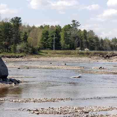 Rock Peter in the Dennys River, across from Dock Brook.: Dock Brook now flows through a culvert where Dock Bridge once stood in Dennysville, as viewed at low tide from Rock Peter on the Edmunds side of the Dennys River.