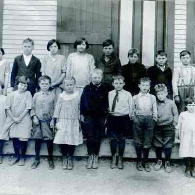 Grammar School at lower Dennysville, 1916.: The Grammar School at lower Dennysville, in the Tide Mill District schoolhouse., c. 1916.  Rebecca Hobart writes:  "The students being taught by Edith McRae in the lower Dennysville school in 1916 were Arthur Antone, Abbey, Theodore and Julia Dudley; Grace and Richard Dunn; Mary and Pearl Jones; Aleta and Richard Lyons; Clyde and Philip Mattheson; Harry Morgan; Emerson and Frank Munroe; Alice, Beulah Millard and Ruth Preston; Eleanor Sherrard; and Lydia and Winnie Sprague.