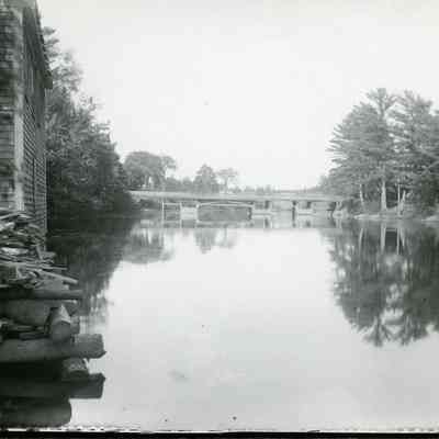 Lower Bridge over the Dennys River, c. 1890: View of the Lower Bridge over the Dennys River as seen from behind Gardner's store in Dennysville, Maine.  Photograph by John P. Sheahan, courtesy of the Tides Institute, Eastport, ME.