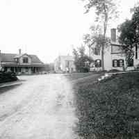          Store Hill After 1909, Dennysville, Maine; Store and G. A. R. Hall across the street, Howard Laughton's barber shop on left, and Benjamin Foster's and Will Allan's houses on right.
   