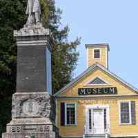          The Soldier's Monument in Dennysville, Maine; The former Dennysville Academy and Church Vestry, now the Academy/Vestry Museum of the Dennys River Historical Society stands sentinel over the veterans' memorial in 2023.
   