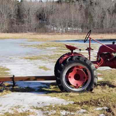 Vintage Farmall tractor with sickle bar.: Located at the Brown house Dennysville , Maine.
