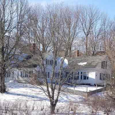 Winter View of the T.W. Allan house in Dennysville, Maine.: The three distinct sections of the house are visible through the leafless trees.